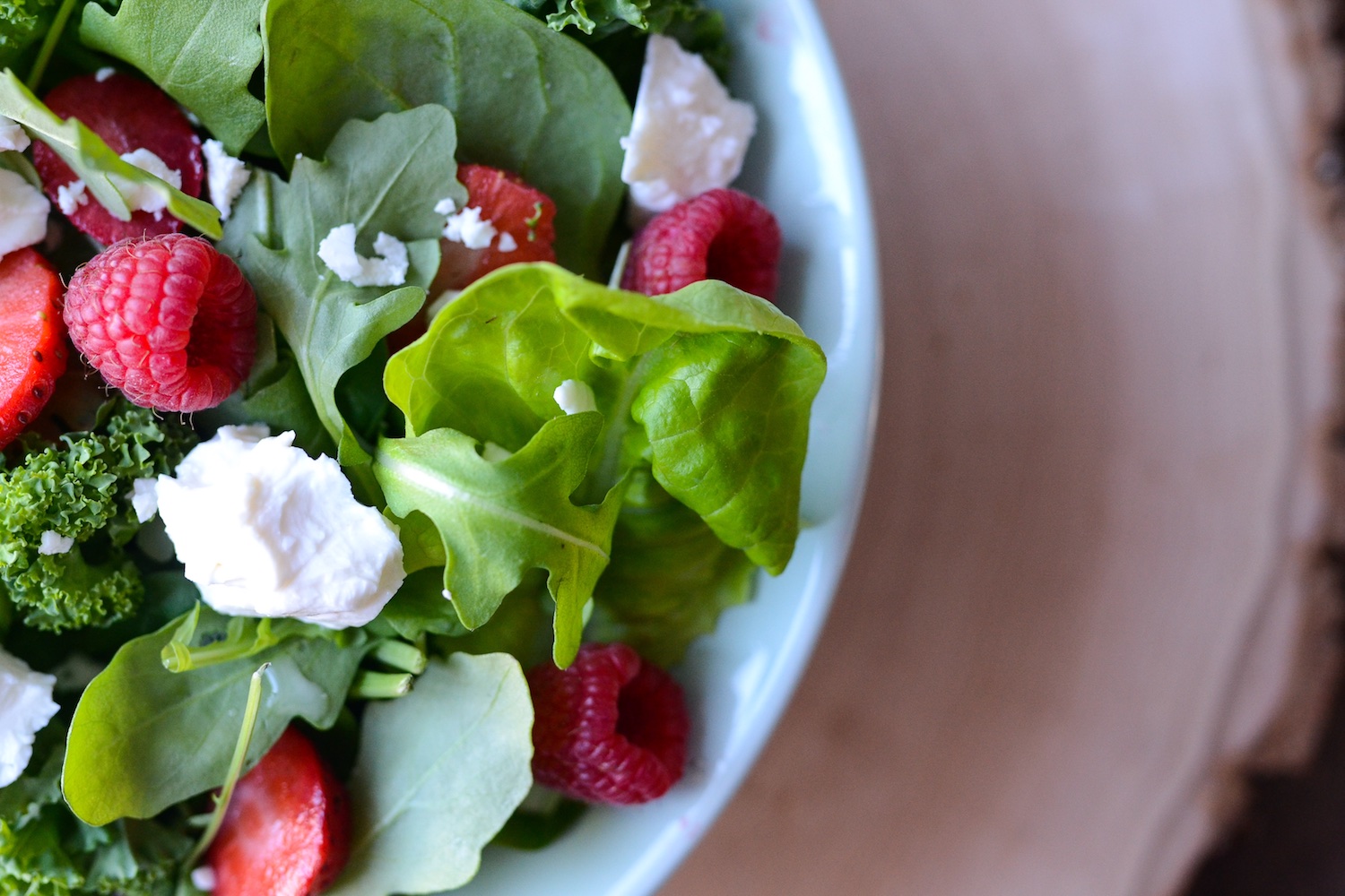 Spinach salad with kale with feta, strawberries and raspberries