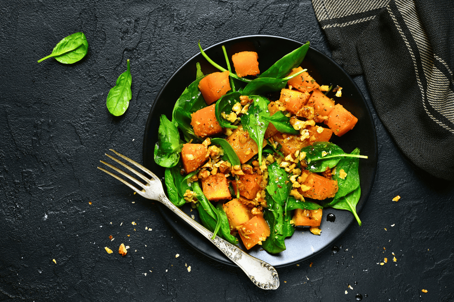 Spinach, spicy squash and walnut salad.