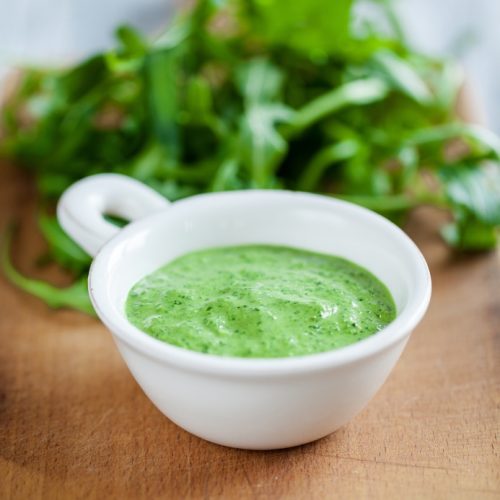 Pesto dans une tasse sur planche de bois avec feuille de roquette / arugula pesto with walnut on wooden